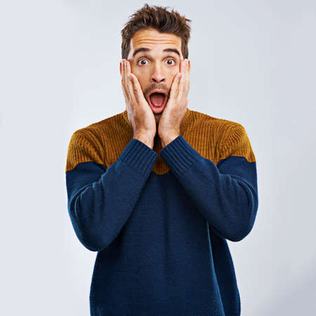 I cant believe it. Portrait of a handsome man expressing surprise against a gray background.の写真素材