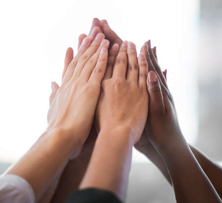 We can do this together. Cropped shot of an unrecognizable group of businesspeople giving each other...