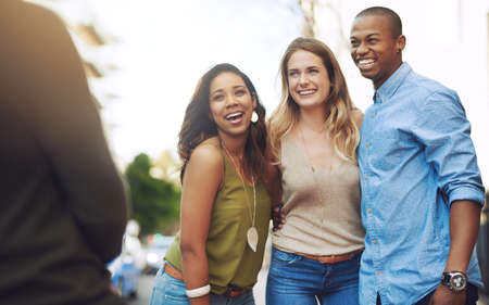 It was a day to remember. Shot of a group of young friends having their picture taken outdoors.