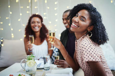 Im having such a good night out. Cropped shot of a group of young friends enjoying a night out.の写真素材