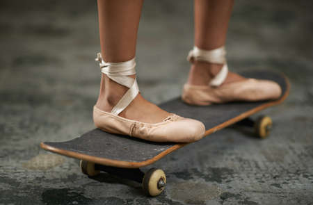 Grace on wheels. A cropped image of a woman in ballet slippers on a skateboard.の写真素材