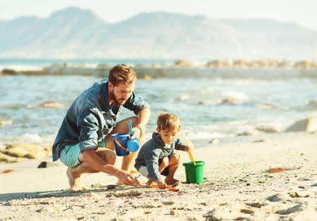 So the adventure begins. Shot of a young Father and son spending quality time at the beach.の写真素材