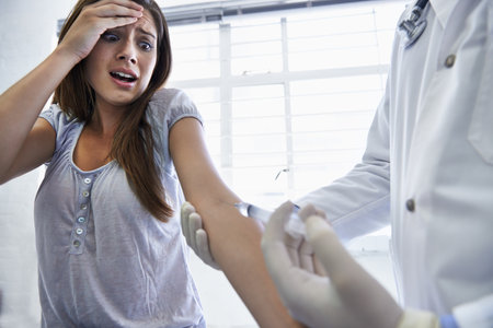 This wont hurt a bit. A doctor giving a woman an injection.の写真素材