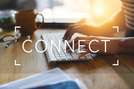 Shes connected. Cropped shot of an unrecognizable businesswoman typing on a bluetooth keyboard behind the word connect.の写真素材