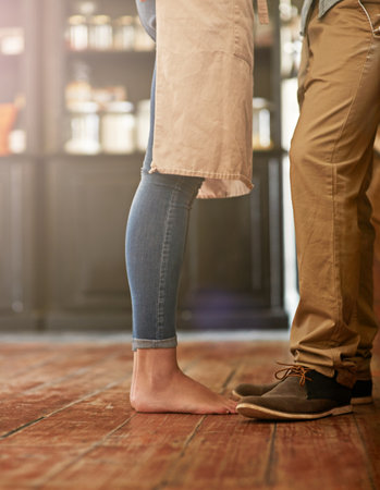 The kitchen is the heart of the home. Cropped shot of a couple standing close to each other.の写真素材