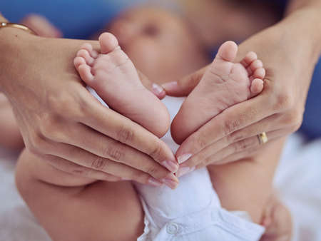 The places these tiny feet will take him one day.... Cropped shot of a mother holding her babys...