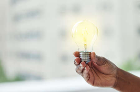 Whats achieved today was once just an idea. Shot of an unrecognisable businesswoman holding a lightbulb.の写真素材