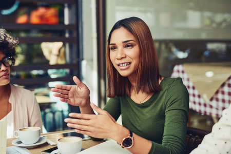 Explaining her point of view over the matter. Cropped shot of designers having a meeting at a coffee shop.の写真素材