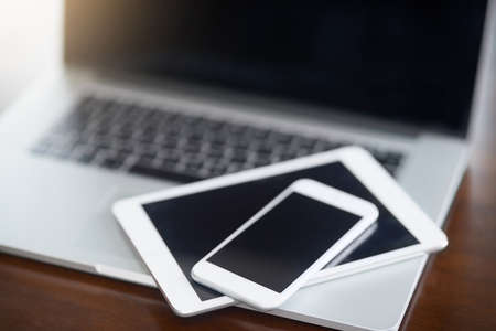 Digital devices at the ready. High angle shot of various digital devices on a table.の写真素材