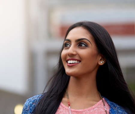 What a beautiful day. Shot of an attractive young woman walking outside.