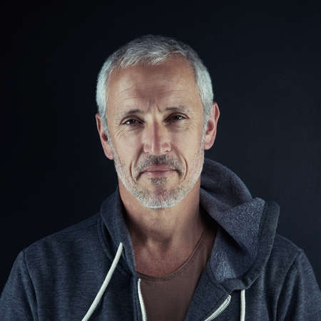 Live life actively. Portrait of a man posing against a dark background.の写真素材