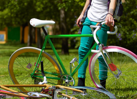 Getting his bike, then heading home. Cropped shot of a young guy standing next to his bike outdoors.の写真素材