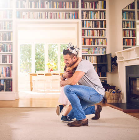 Daddy loves you with his whole heart. Shot of a father hugging his little daughter at home.の写真素材