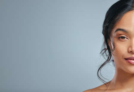 Good skincare is an investment. Studio portrait of an attractive young woman posing against a grey background.の写真素材