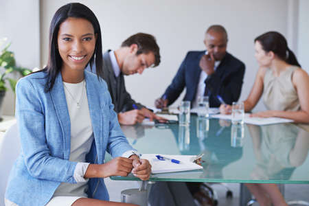 Shes a valued employee in this organization. Portrait of a young businesswoman with her colleagues...