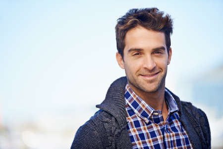 Wearing my happy today. Shot of a handsome young man spending a day outdoors.