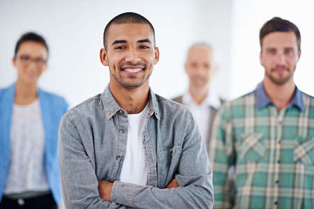 Im in the right place, at the right time. Young businessman smiling confidently with colleagues in...