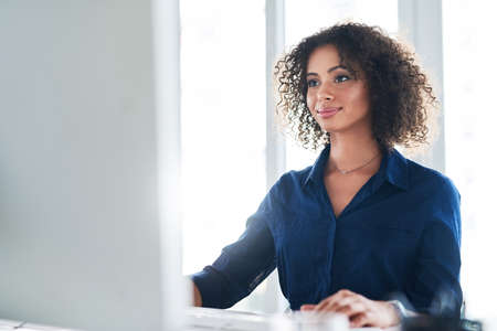 Getting things done is what she does. Cropped shot of an attractive young businesswoman working at...