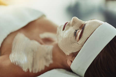 Bring on the day of pampering. Shot of an attractive young woman relaxing on a massage bed at a...