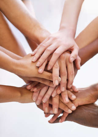 Showing solidarity. Shot of a group of people putting their hands together.の写真素材