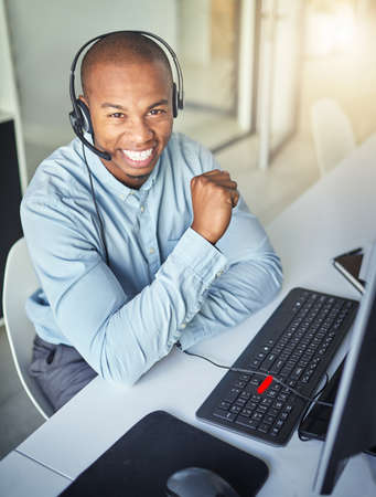 Friendly customer support is just a call away. Cropped shot of a young handsome male customer...