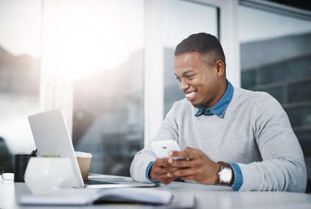 Let me send through these details to the client. Shot of a handsome young businessman using a...