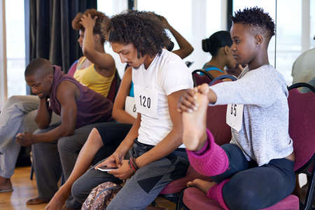 Soon.... Shot of a group of young dancers sitting and waiting for their dancing auditions.