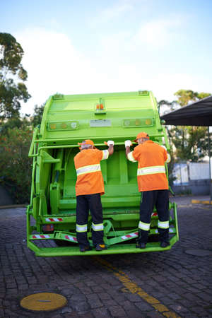 Garbage collection day. Cropped shot of a garbage collection team at work.