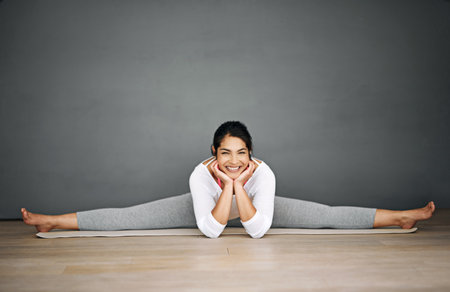 Yoga is the best way to start the day. Portrait of an attractive young woman doing the splits in her yoga routine.の写真素材