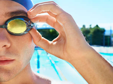 Driven to sporting excellence. Cropped portrait of a handsome male swimmer getting ready to compete.