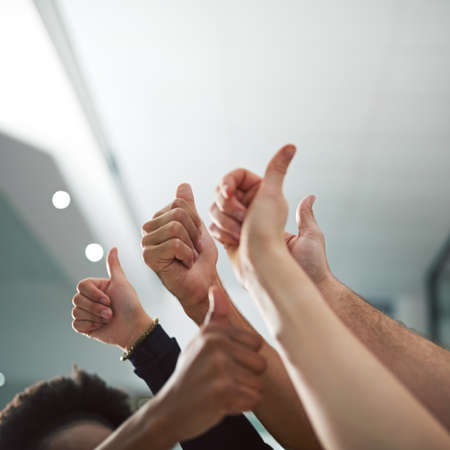 We say yes to success. Cropped shot of various peoples hands showing thumbs up.の写真素材