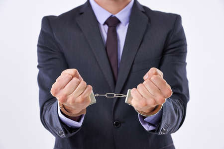 Ive made terrible decisions. Cropped studio shot of a businessman in handcuffs.の写真素材