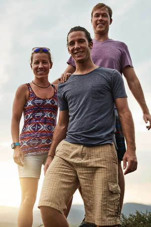 Finding happiness in hiking. Portrait of three happy friends posing together during a hike in the...