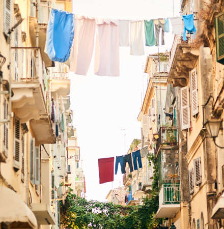 Its a different way of life. Low angle shot of clothing hanging from clothing lines between buildings in a foreign city.の写真素材