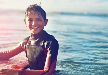 Surfing is all the adventure I need. Shot of a young boy out surfing.
