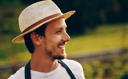 He sowed, now watch him reap. Shot of a handsome young man working in a garden.の写真素材