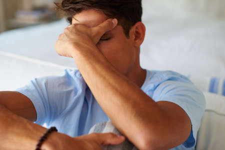 Hes taking it very hard. Shot of a young man looking depressed.