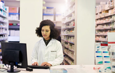 Ill get you the medication you need, when you need it. Cropped shot of a pharmacist working on a computer in a pharmacy.の写真素材