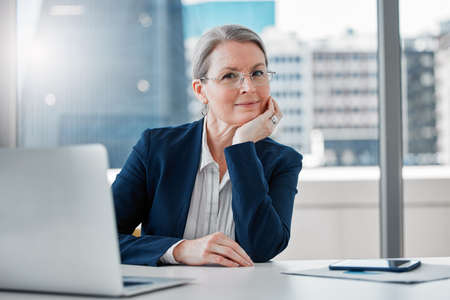 Never let age stop you from achieving goals. Shot of a mature businesswoman sitting alone at her...