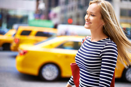 Feeling confident today. Shot of a gorgeous woman walking in the city.の写真素材