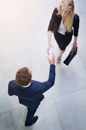 Welcoming the new associate. Shot of two businesspeople shaking hands.の写真素材