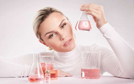 She is wine of love. Studio shot of young woman making a potion against a white background.