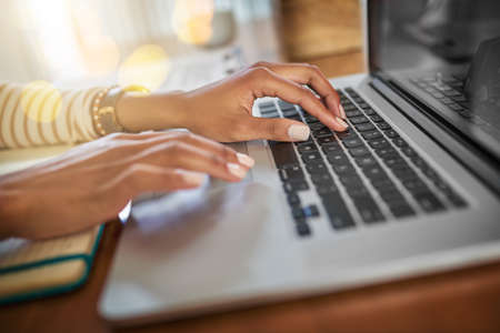 Time to get down to work. Closeup shot of an unrecognizable woman working on a laptop at home.