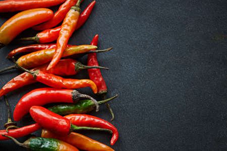 The hotter, the better. High angle shot of fresh red chillies on a kitchen counter.