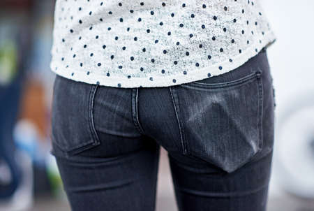 Always in reach. Cropped shot of a young womans butt, with the outline of her cell phone visible in...