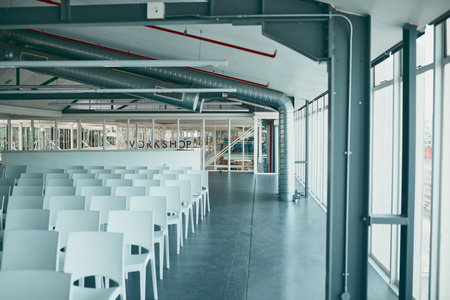 This is where the business starts. Shot of an empty office filled with chairs and surrounded with...
