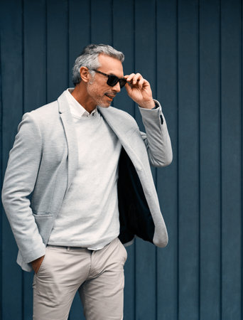 He knows himself and he knows his style. Cropped shot of a smartly dressed mature businessman standing outside.の写真素材