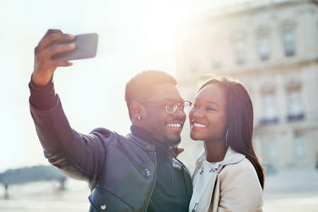 Selfies with my one and only. Shot of an affectionate young couple taking selfies together outdoors.