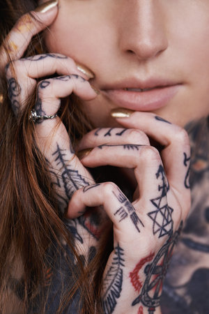 Beauty inkorporated. A cropped shot of a tattooed young woman.の写真素材