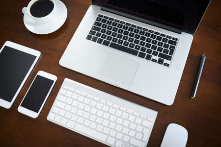 Quick and easy access to the world online. High angle shot of various digital devices on a table.の写真素材